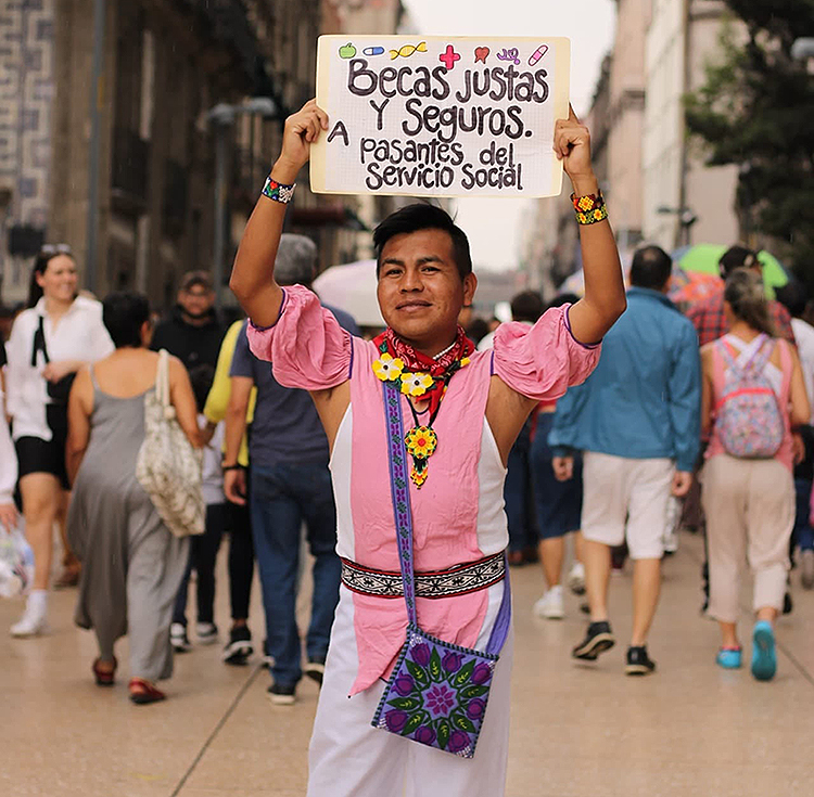 Nursing student, Gabino Valdez, marching for fair scholarships for nursing students, 2023