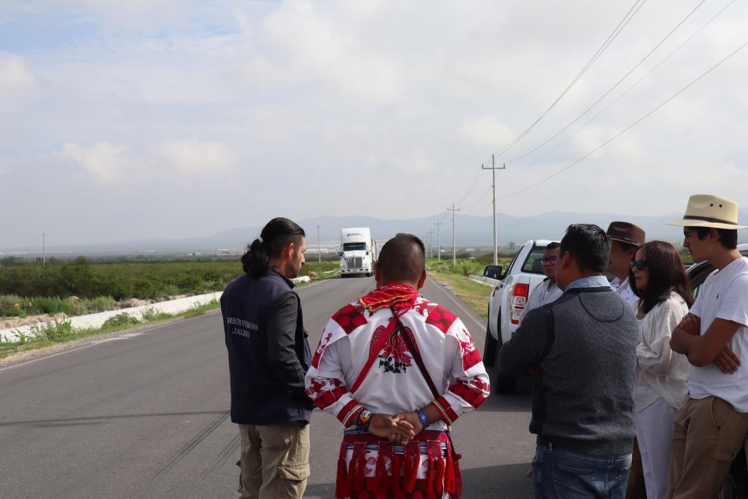 Mexican human rights and Wixarika delegates observe the passing of egg cargo from the new industrial plants. Photography by Author, 2022.